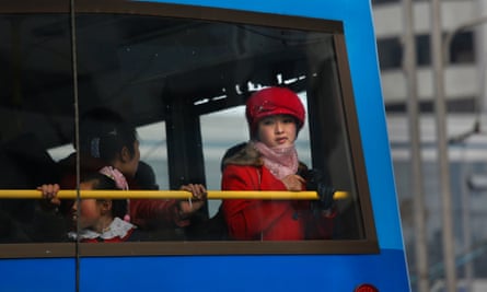 A woman framed a bus window in Pyongyang.