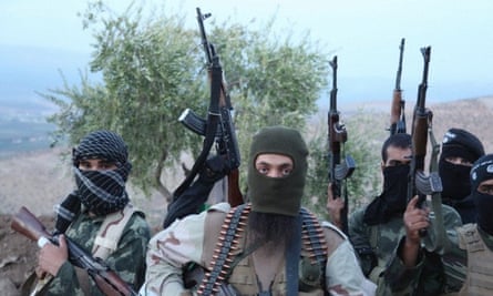 Isis militants in balaclavas with guns in the air