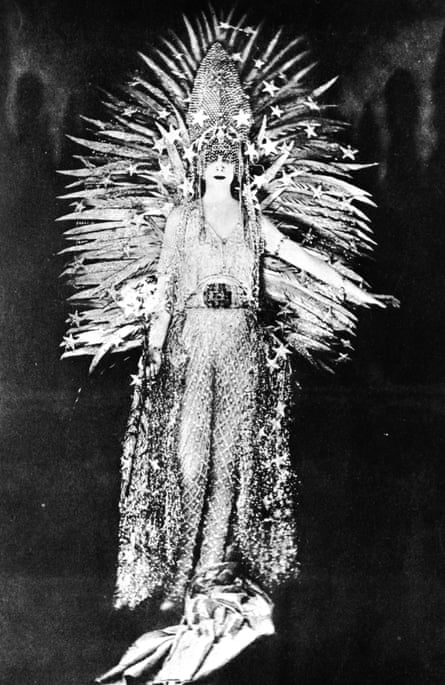 Marchesa Luisa Casati wearing a costume symbolising light to a fancy dress party in Paris, 1922. The costume, designed by Worth, is made of a net of diamonds, incorporates a gold feather sun against a diamond tiara and has a glittering silver fringe.