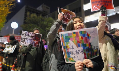 Protesters march in front of Shinzo Abe's official residence against the state secrets law.