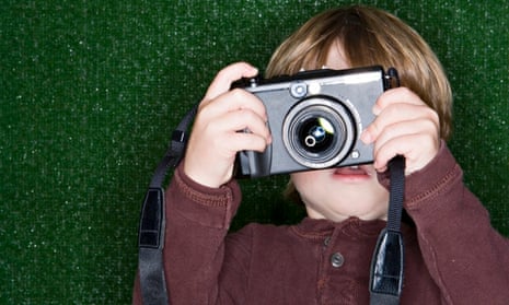 Family: Boy (2-4) taking photograph with digital camera