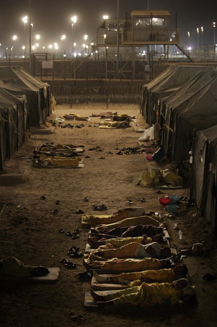 Iraqi detainees sleeping outside their tents in Camp Bucca, Iraq