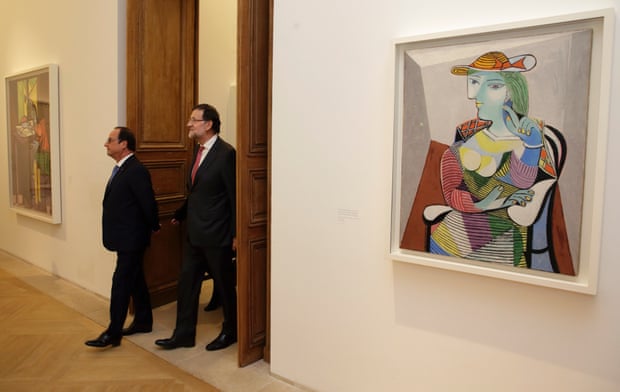 Francois Hollande (L) and Mariano Rajoy walk past the painting Portrait of Marie-Therese (1937) by Pablo Picasso at the Picasso Museum