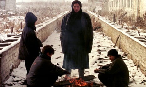 Chechen refugees stand around a fire in the village of Nasyr-Kort during the second war. Chechnya