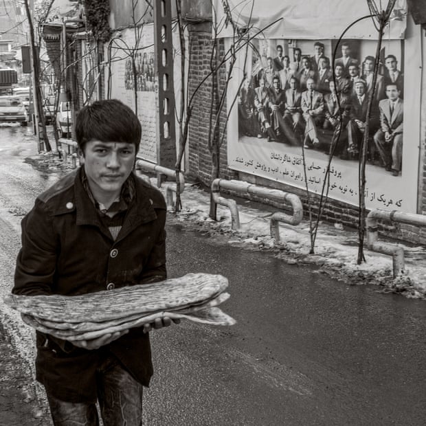 A young man carries freshly baked barbari bread in Tehran, Iran.