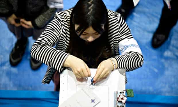 Opening a ballot box in Japan's recent general election … only 169 women stood out of 1,093 candidat