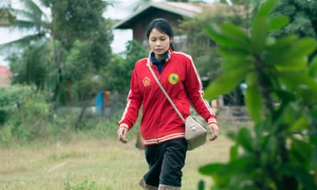 Alisa Xaysithideth walks to the youth health clinic near her village in the Kaisone district.