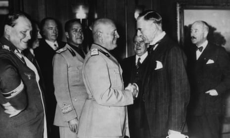 Chamberlain (right) shakes hands with Mussolini after signing the Munich Agreement while Hitler and other European leaders look on, 30 September 1938.