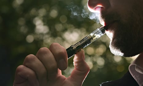 A man smokes an e-cigarette