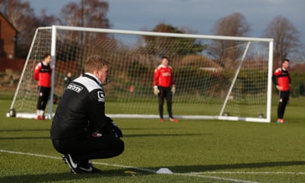 Howe watches on during a training session.