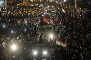 <strong>Sanliurfa, Turkey <br></strong>29 October: Kurds in Turkey greet peshmerga convoys at Viransehir. Heavily armed Kurdish peshmerga fighters were on their way by land and by air, joining militias defending the Syrian border town of Kobane, also known as Ain al-Arab, from the Islamic State group after setting off from Iraq