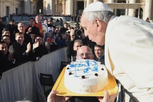 Pope Francis blows candles on a cake