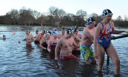 LONDON, ENGLAND - DECEMBER 25:  Members of the Serpentine Swimming club leave the water after taking part in the annual Christmas Day morning 100 yards 'Peter Pan Cup' race