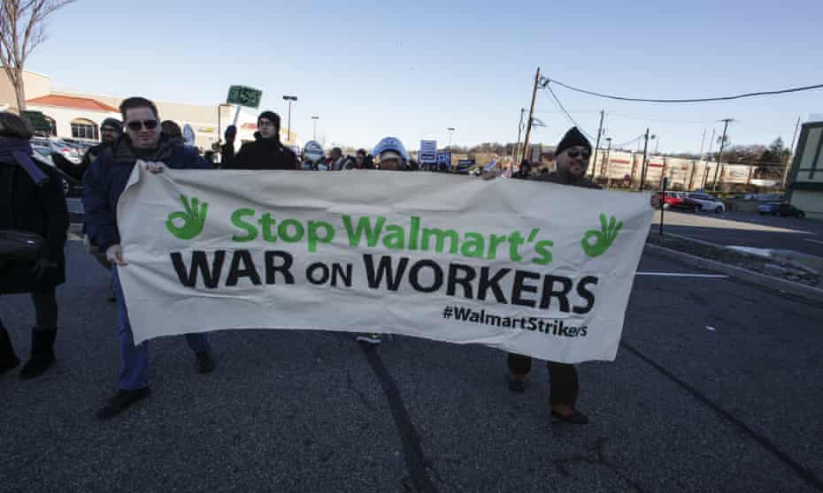 Marchers hold Walmart Strikers banner in Walmart parking lot in New Jersey in November 2014. They were protesting against employee mistreatment.