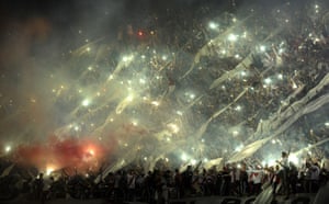 10 December: Supporters of Argentinian football side River Plate cheer for their team during the Copa Sudamericana 2014 final against Colombian team Atletico Nacional at the Monumental stadium in Buenos Aires, Argentina