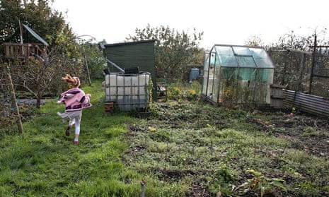 Girl running away from us on an allotment