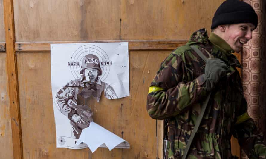 Ukrainian soldiers use a poster of Russian actor Mikhail Porechenkov for target practice. Porechenkov is said to have joined separatist militia shooting at the Donetsk airport.