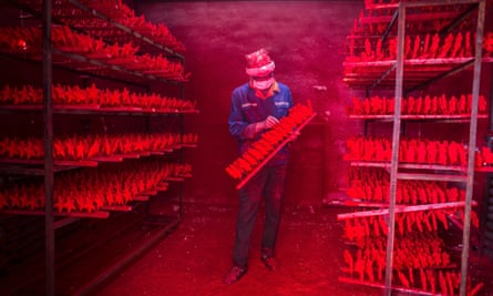 The two men produce 5,000 red snowflakes a day, and get paid around £300 a month.