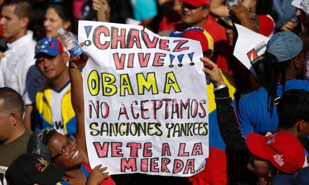 Supporters of President Nicolas Maduro hold a banner during a rally to reject US sanctions against Venezuela.
