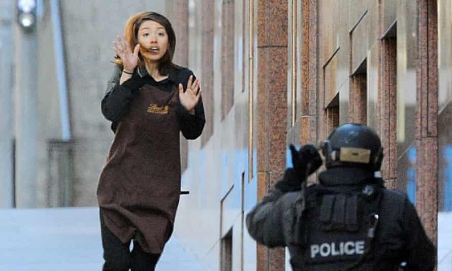 Elly Chen runs for safety after fleeing the cafe.