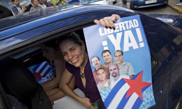 A woman in Havana with a poster of the Cuban Five celebrates their release from a Flordia jail after