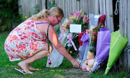 Woman lays flowers near scene of Cairns stabbings