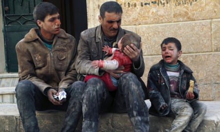 A man holds a baby saved from under the rubble after an air strike by regime forces.