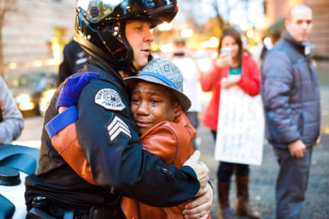 'The cop appears to be comforting the boy. After all the anger, all the divisions, here is a moment of human reconciliation. What nonsense.'
