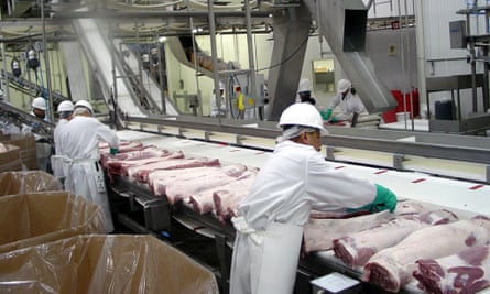 Workers process pork at a hi-tech plant in Illinois.