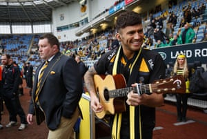 Reality star from I’m a Celebrity and X Factor Jake Quickenden warms up to sing as the Wasps director of rugby, Dai Young walks past.