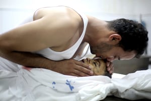 Brother weeping over dead boy in Gaza City hospital
