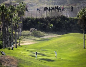 migrants on fence at Spanish golf course