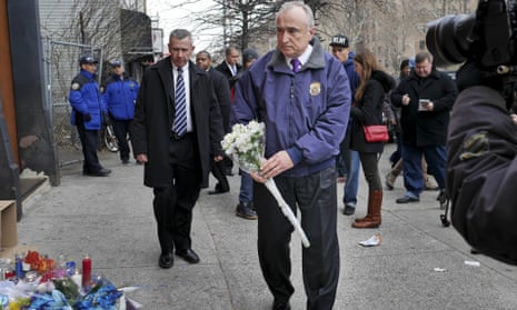 New York City Police Commissioner Bill Bratton leaves flowers at an impromptu memorial near the site where two police officers were killed in Brooklyn, New York, Sunday.