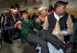 Wounded schoolboy being carried into hospital after the attack in Peshawar