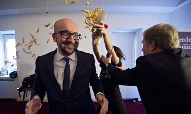 Activists throw fries and mayonnaise over the Belgian prime minister, Charles Michel, in a protest b