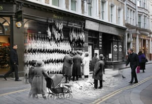 Christmas turkeys hanging outside a poulterers in Watling Street, London, in December 1923, where today shoppers bustle past