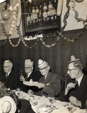 Spurs Chairman Fred Bearman, 2nd left, sits with his fellow directors under a photograph Of The 1921 F.A. Cup Winning Team as they tuck in at the 1960 Tottenham Hotspur Christmas Party