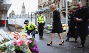 Glasgow, Scotland First Minister of Scotland Nicola Sturgeon, Lord Provost Sadie Docherty and Glasgow Council leader Gordon Matheson look at flowers left near the scene of yesterday's crash. Six people were killed and eight injured after a bin lorry careered out of control in Queen Street in the city centre and ploughed into pedestrians