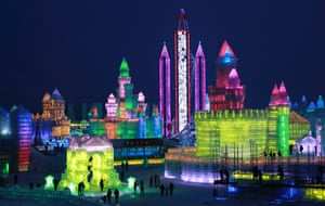 Heilongjiang province, China People visit newly-built ice sculptures illuminated by coloured lights during a trial operation of the 16th Harbin Ice and Snow World