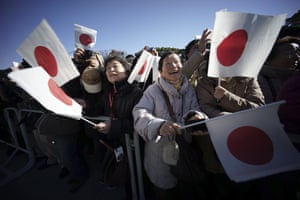 Tokyo, Japan Well-wishers wave Japanese flags to celebrate Japan's Emperor Akihito's 81st birthday at the Imperial Palace