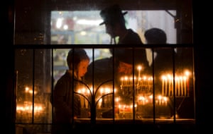 Bnei Brak, Israel An ultra-Orthodox Jewish family light candles during the last day of Jewish holiday of Hanukkah. The Jewish festival of light is an eight-day commemoration of the Jewish uprising in the second century B.C. against the Greek-Syrian kingdom, which had tried to put statues of Greek gods in the Jewish Temple