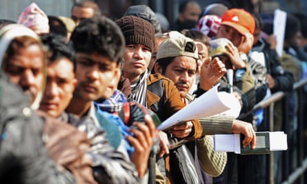 Nepalese migrant workers queue to receive official documents in order to leave Nepal from the labour department in Kathmandu.