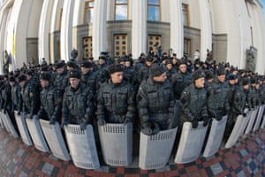 Kiev, Ukraine Policemen stand guard during Ukrainians rally in front of the Parliament as Ukrainian lawmakers discuss about state budget for 2015. The Ukrainian parliament also voted overwhelmingly on 23 December in favour of dropping the country's non-aligned status, taking a major step toward NATO membership.