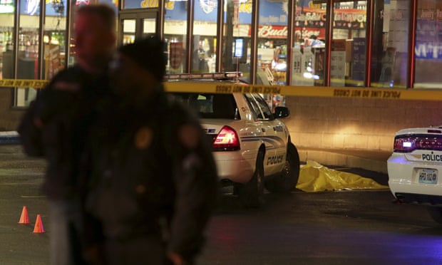 Police stand guard following a shooting Tuesday at a gas station in Berkeley, Missouri