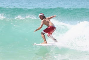 Sydney, Australia Valeria Cicconi from Rome, Italy, rides a wave at Bondi Beach on Christmas day.