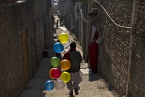 Islamabad, Pakistan A balloon vendor looks for customers in a Christian neighbourhood.