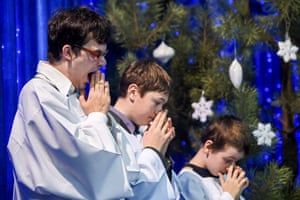 Altar boys attend a Christmas mass at the Catholic Church of St. Simon and Helena (Red church) in Minsk
