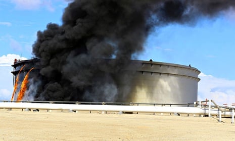 Black smoke billows out of an oil tank