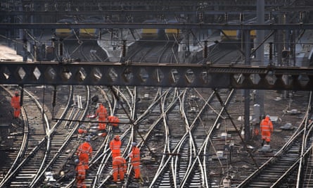 Railway workers on the tracks outside King's Cross, London, as trains in and out of the station have been cancelled.