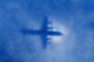The shadow of a Royal New Zealand Air Force P-3 Orion aircraft is seen in low cloud cover on a search for missing Malaysia Airlines Flight MH370 in the southern Indian Ocean.